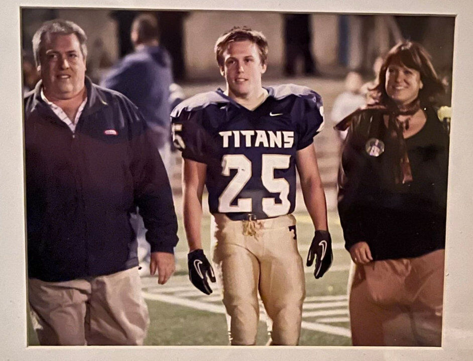 Jimmy Howe and his parents in high school football uniforms